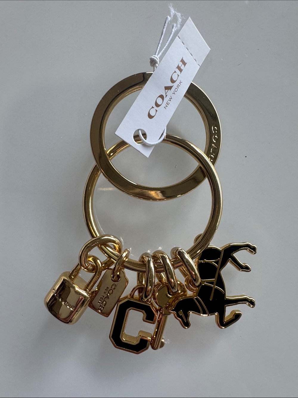 Coach Gold and Black Charm Keychain with Horse & 'C' Logo
